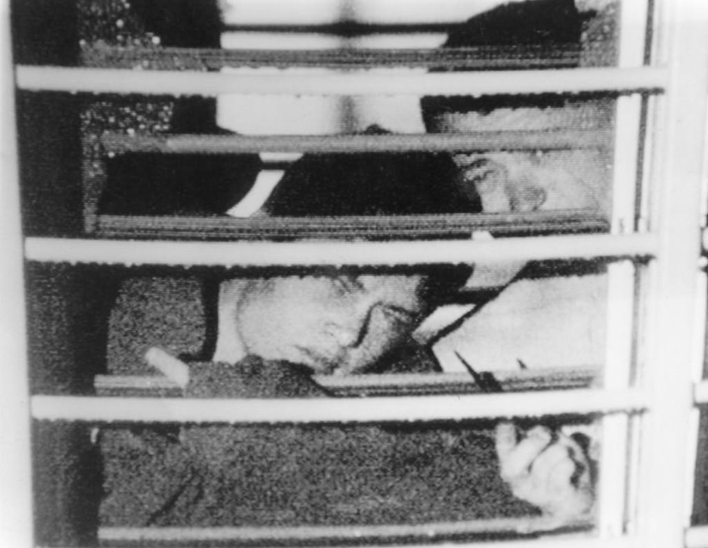 Two boys seen through bars across a window at Westboork Boys Home